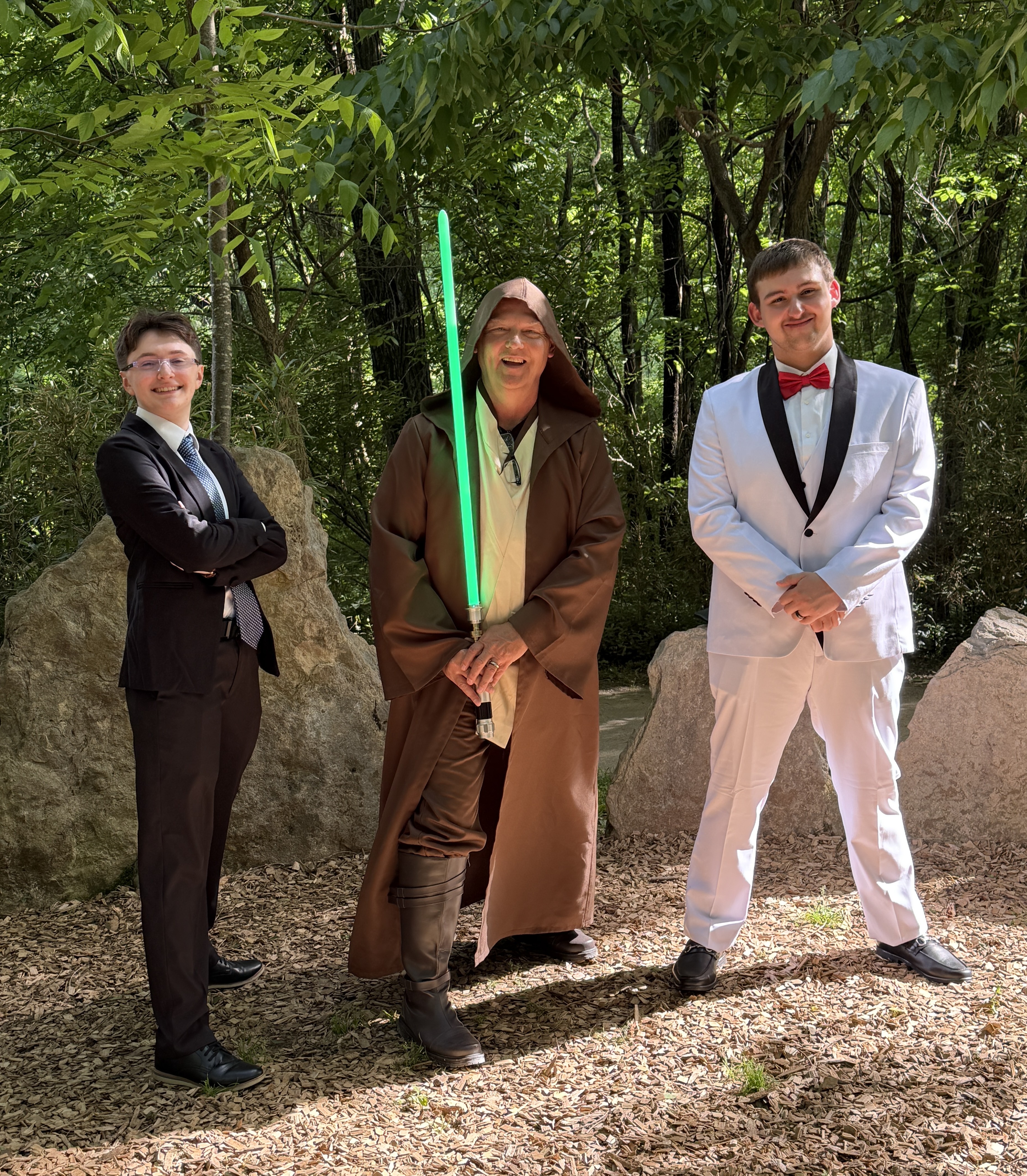 Kevin dressed as Jedi officiant with lightsaber at Star Wars themed wedding